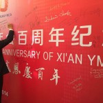 Signing a commemorative banner at the Xi’an YMCA anniversary celebration