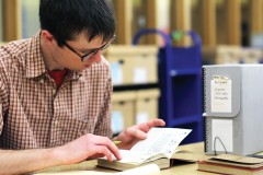 A researcher in the Andersen Library reading room