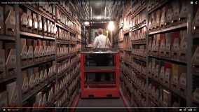 Inside the archives with man on book picker