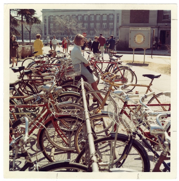 Student at bike rack near Northrop Auditorium with Morrill Hall in the background, 1968. Available at http://purl.umn.edu/80607
