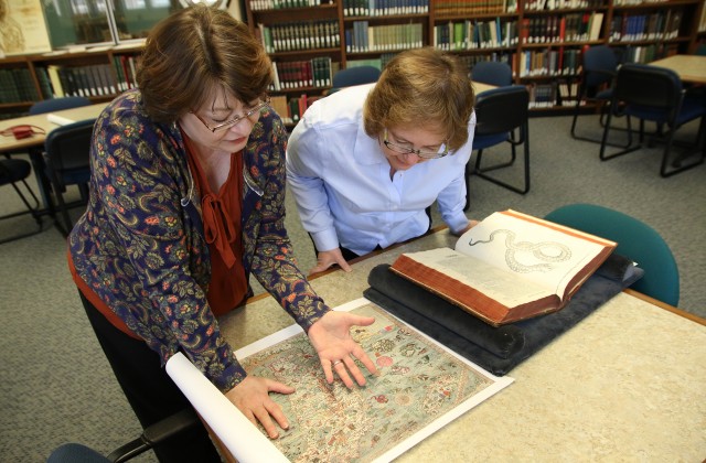 Maggie Ragnow and Lois Hendrickson inspect maps