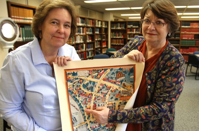 Lois Hendrickson and Maggie Ragnow holding 1935 campus map