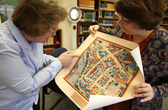Lois Hendrickson points out the sea serpent in 1935 campus map