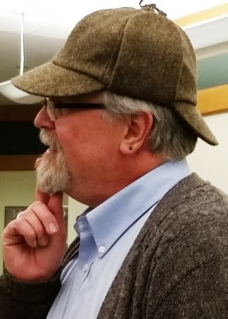 Curator Tim Johnson wearing a deerstalker hat.