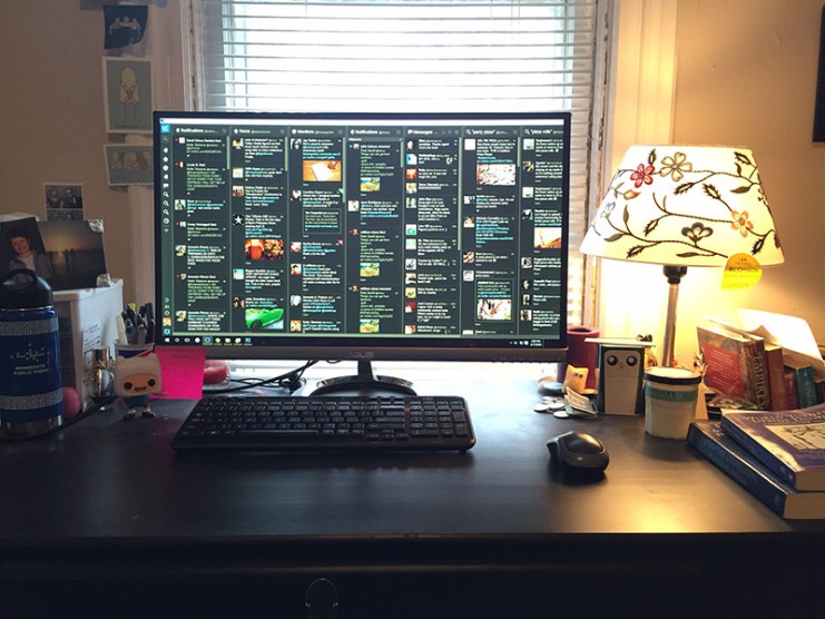 Katie's desktop setup, including a computer monitor with Tweetdeck running.