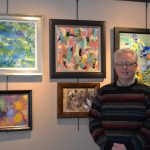 Artist Ron Duffy with paintings from the Brushed Back to Life series.