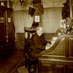Photo of Robert R. McBurney, the “first paid secretary” of the YMCA sitting at his desk.