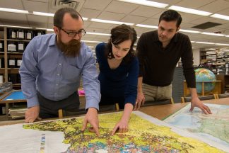 Ryan Mattke with graduate students in the Map Library