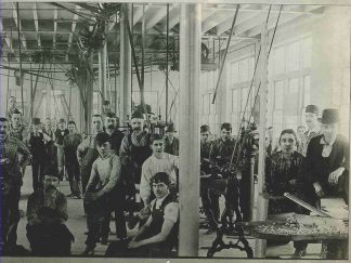 Group portrait of Burroughs Corporation machinists on the factory floor., circa 1900.