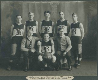 Employee basketball team and coaches in formal portrait, center figure holding a ball with “06-07” painted in white.