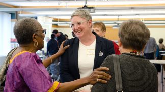 Cecily Marcus (center) greets a guest