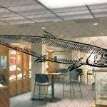 Vinyl cutter prints adhesive design elements, like this fish for the Underwater exhibit at the Wangensteen Historical Library.