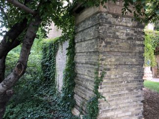 A remnant of the Northrop Field wall and pillar at the southwest corner of the Armory.