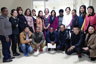 Elizabeth Wattenberg poses with Professor Thị Hoàn Lê, Head of the Department of Environmental Health at Hanoi Medical University (center, back) and the 2017-2018 class of the MPH program.