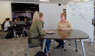 Carlson student Anne Schwappach consults with her professor Julia Van Etten, faculty member in Marketing at the Carlson School of Management.