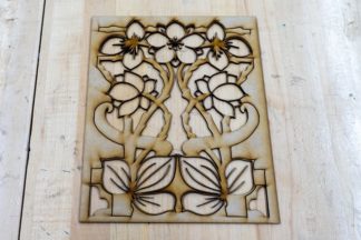 Photo of finished laser cut of a floral design in wood.