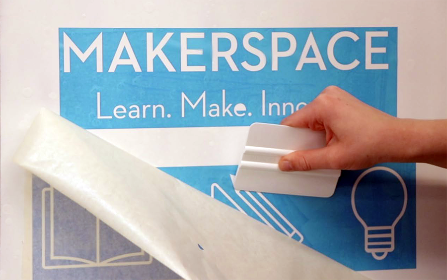Photo of person using a stencil made at the Makerspace
