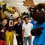Goldy and Mooster pose with three Gopherbaloo students