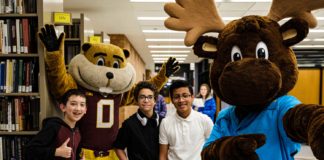 Goldy and Mooster pose with three Gopherbaloo students