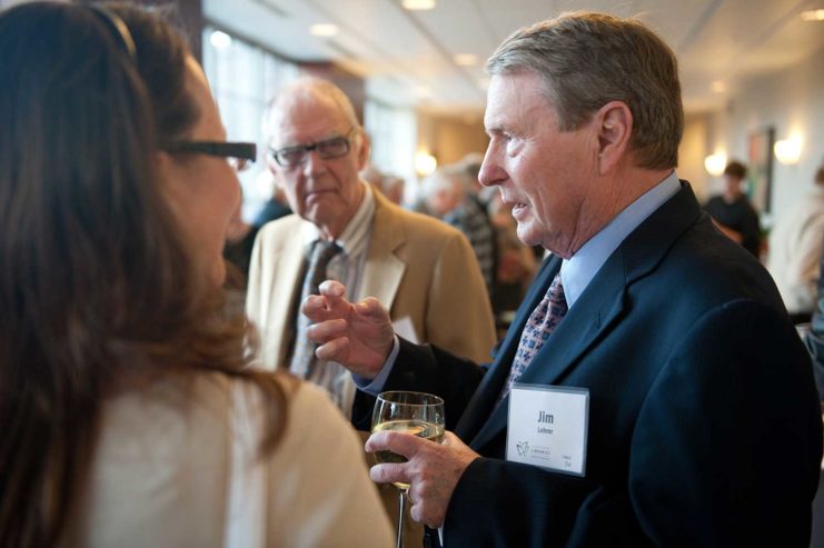 Jim-Lehrer talking with guests