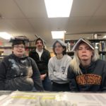Colleagues with books on their heads