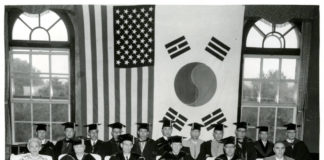 A photograph of the ceremony for the conferment of an Honorary Doctorate (Law) on the Honorable Arthur E. Schneider. The date is unknown. Source: University of Minnesota Archives, Photograph Collection.