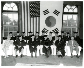 A photograph of the ceremony for the conferment of an Honorary Doctorate (Law) on the Honorable Arthur E. Schneider. The date is unknown. Source: University of Minnesota Archives, Photograph Collection.