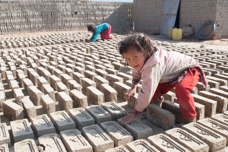 Little Girl Turning Drying Bricks, Nepal