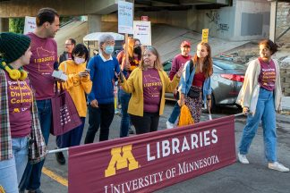 homecoming parade 2021 - the walk begins with libraries banner