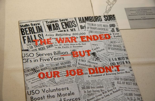 Poster with newspaper headlines and a title of "The War Ended But Our Job Didn't"