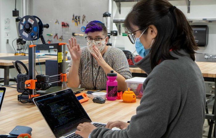 Librarian Carolyn Bishoff gives 3D printing tips to student Changye Li in the Health Sciences Library Makerspace.