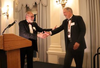Tim Johnson, invited to become a member of the Baker Street Irregulars, received his investiture from Michael Kean. (Photo courtesy Ben Vizoskie and the Baker Street Irregulars.)
