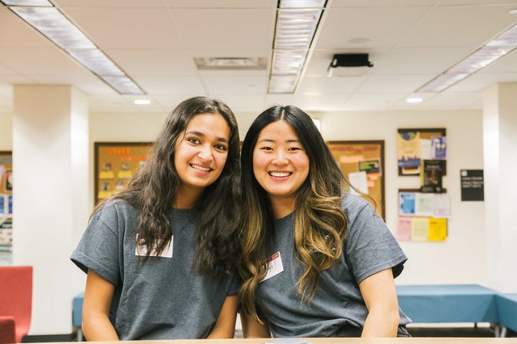 two students pose for the camera and smile