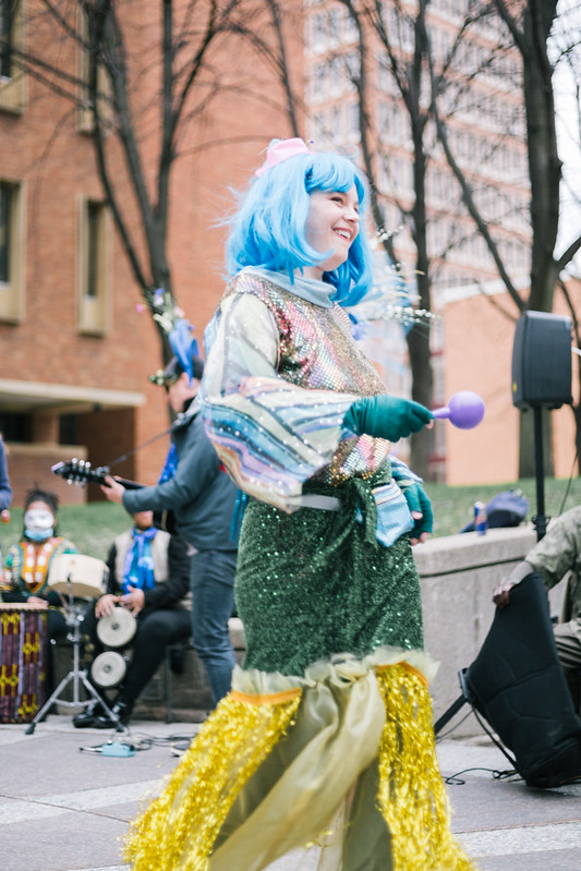 A performer in a blue wig and costume