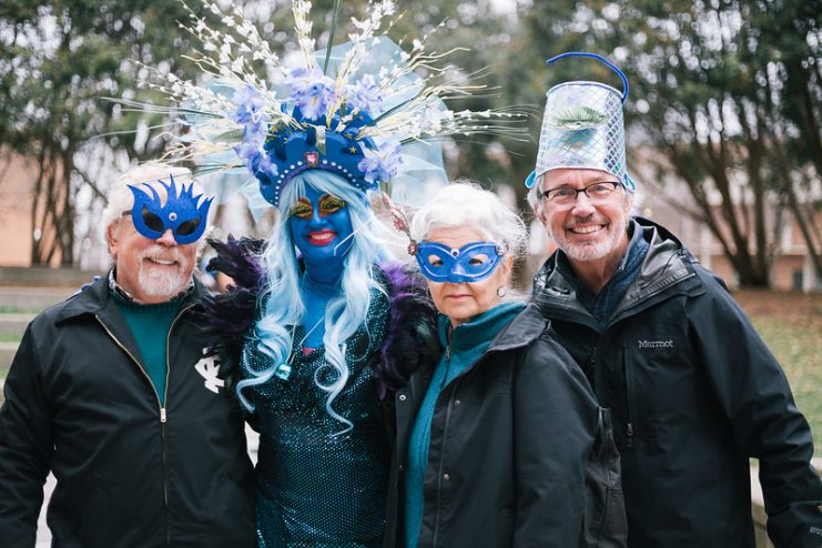 The Blue Lady with guests wearing hats and masks made at the costume making table