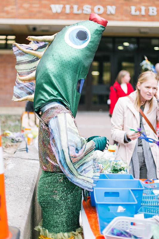 a person in a shimmery green fish costume