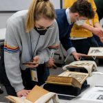 Heidelberg students examine rare books in the Wangensteen Historical Library.