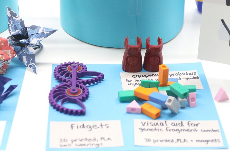 3D printed items made by students including fidgets, visual aids for genetic fragment combos, and equipment protectors