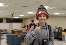 Middle school child wearing several stocking caps at one time.