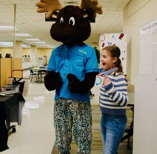 Moose History Day mascot + child winner of raffle.