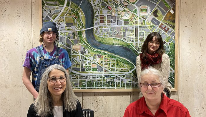 Freshly installed, students (sitting, from left) Ellen Schillace, Aimee Sutherland, (standing, from left) Ty Schwantz, and Jacquelyn Fay in front of their artwork. Not pictured: Bryce Mason. Photo by Russ White for the University of Minnesota Department of Art.