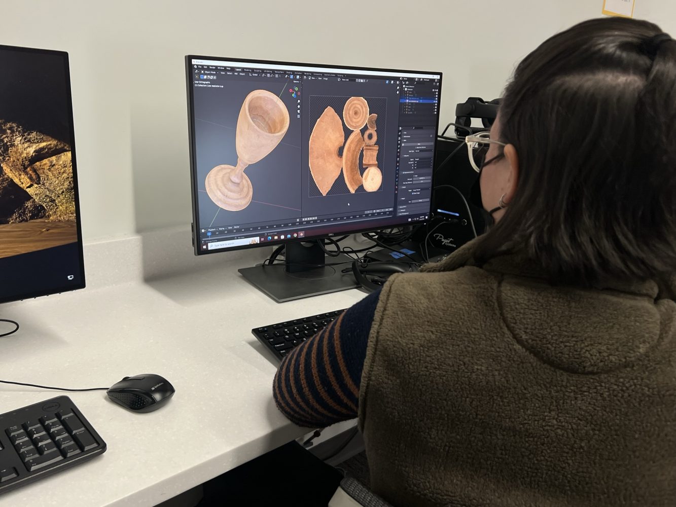 A library staff member works on post-processing the model in Blender