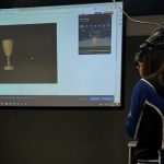 A library staff member experiences the 3D model in virtual reality