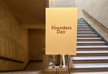 Large white sign on an easel that reads, "Founders Day"
