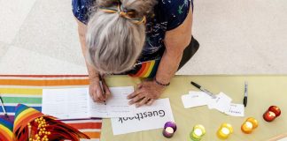 An attendee signs the guestbook for the celebration of life for Jean-Nickolaus Tretter on Friday, June 23, 2023, in the Elmer L. Andersen Library. (Photo/Adria Carpenter)
