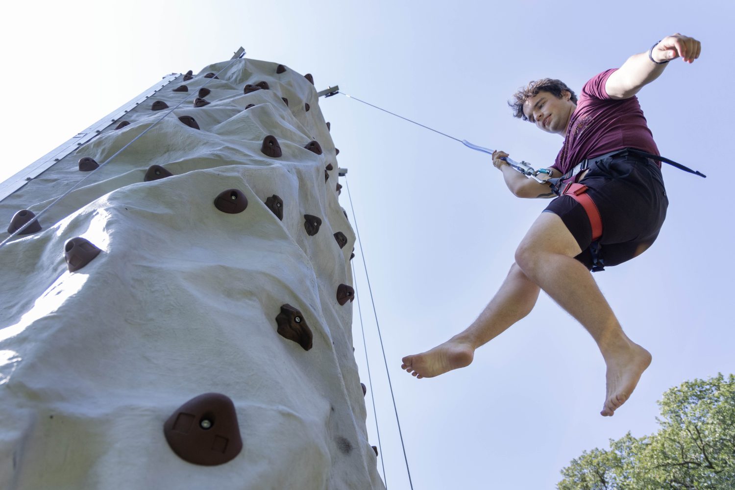 Students scale a climbing wall for Welcome Week. (Photo/Adria Carpenter)
